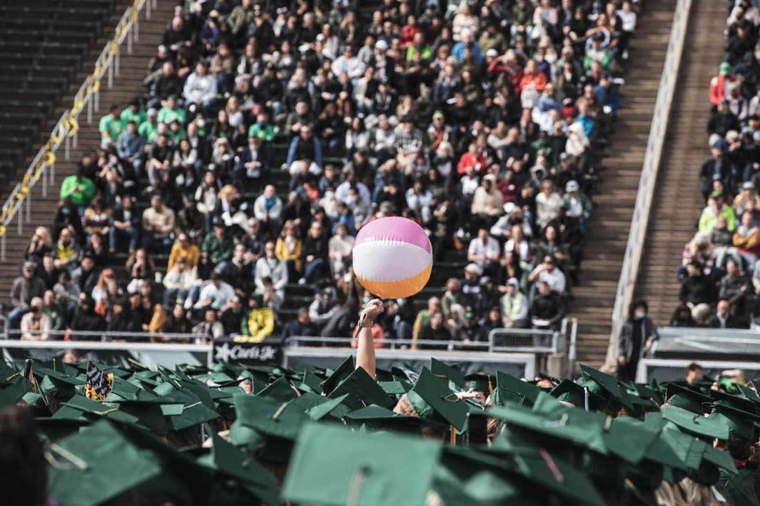 A graduation tradition of passing a beach ball around the crowds of caps begins promptly as graudates are seated. University of Oregon holds its 2022 Commencement Ceremony at Autzen Stadium in Eugene, Ore., on June 13, 2022. (Maddie Stellingwerf/Emerald)