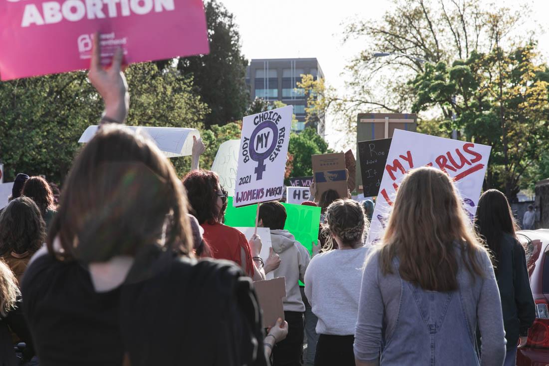 Protesters enter the streets of downtown Eugene with signs and group chants. After a draft of a supreme court opinion would overturn Roe V. Wade was leaked the day prior, hundreds of protesters gathered on May 3, 2022 to march through downtown Eugene in protest. (Maddie Stellingwerf/Emerald)