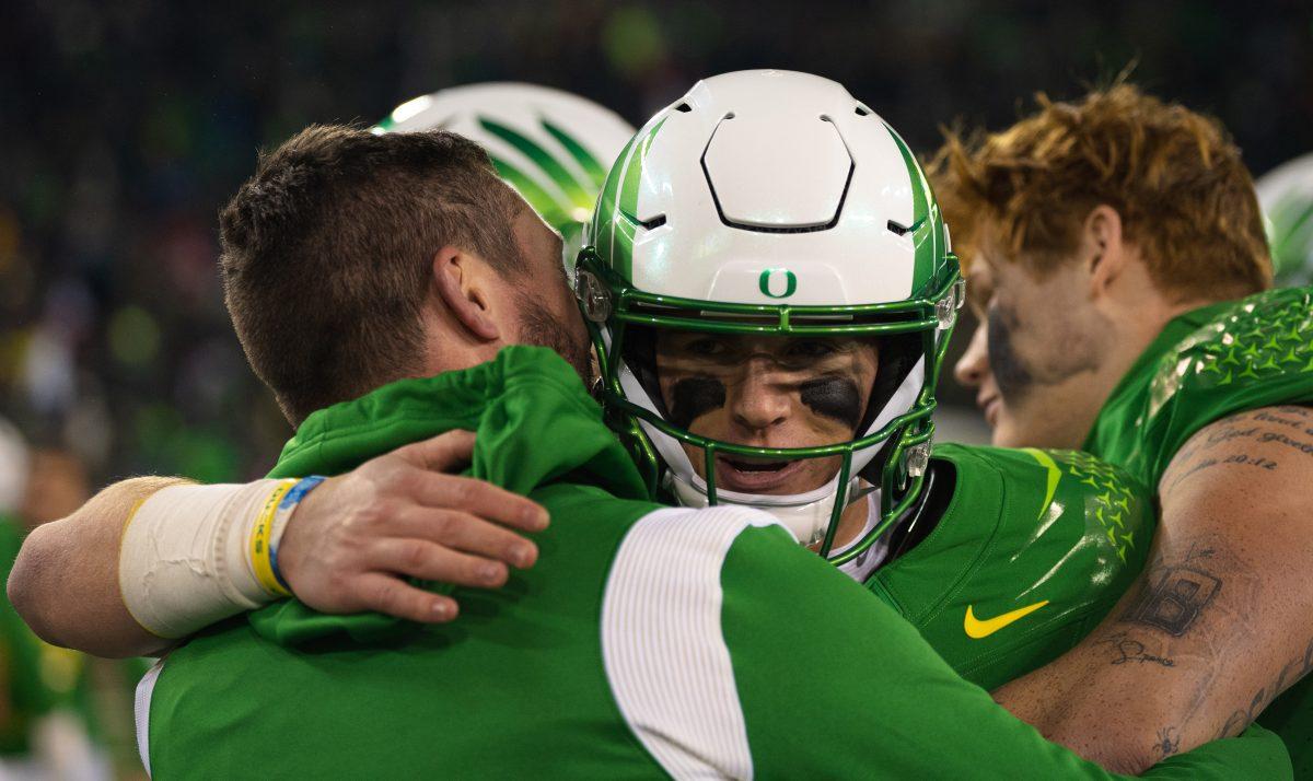 Bo Nix and Coach Lanning share a moment after a big win. This marks Nix&#8217;s last game in Autzen stadium as his Duck career comes to an end. Oregon beats no.10 Utah on November 19th, 2022, at Autzen Stadium. (Liam Sherry, Emerald)