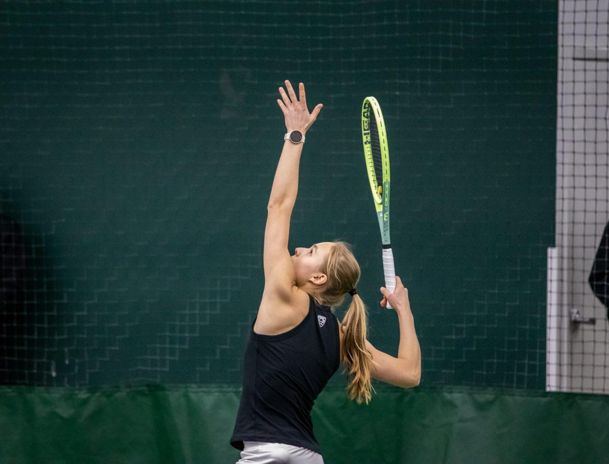 Sophie Lutscher throws the ball up in the air to begin the first match of the day for the Lady Ducks.&#160;The Oregon Women's Tennis team hosts Portland State at the Student Tennis Center in Eugene, Ore., on January 20th. (Jonathan Suni, Emerald)