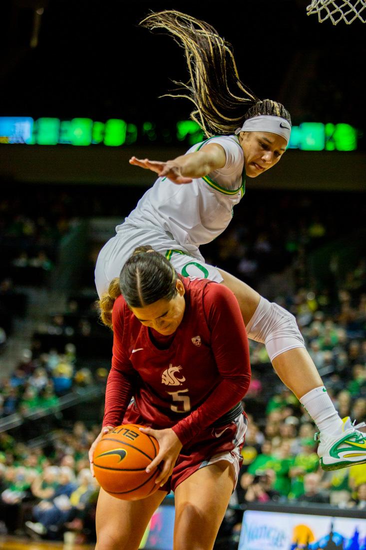 Ducks Endiya Rogers fouls Charlisse Leger-Walker. Oregon Ducks take on the Washington Cougars in Eugene, Ore. (Ali Watson/Emerald)