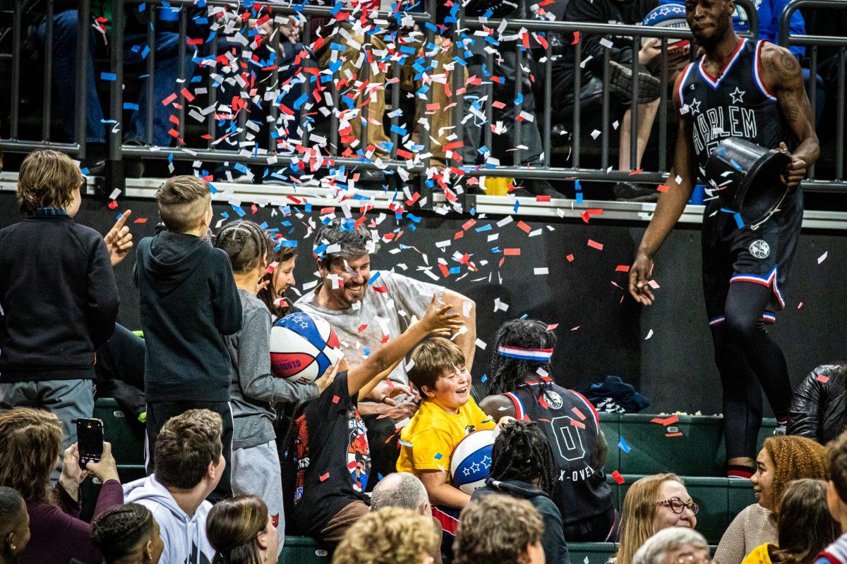 Fans are surprised with a bucket of confetti after the fear of getting water dumped on them.&#160;The Harlem Globetrotters take a stop on their world tour&#160;at Matthew Knight Arena in Eugene, Ore., on Jan. 19, 2023. (Jonathan Suni, Emerald)