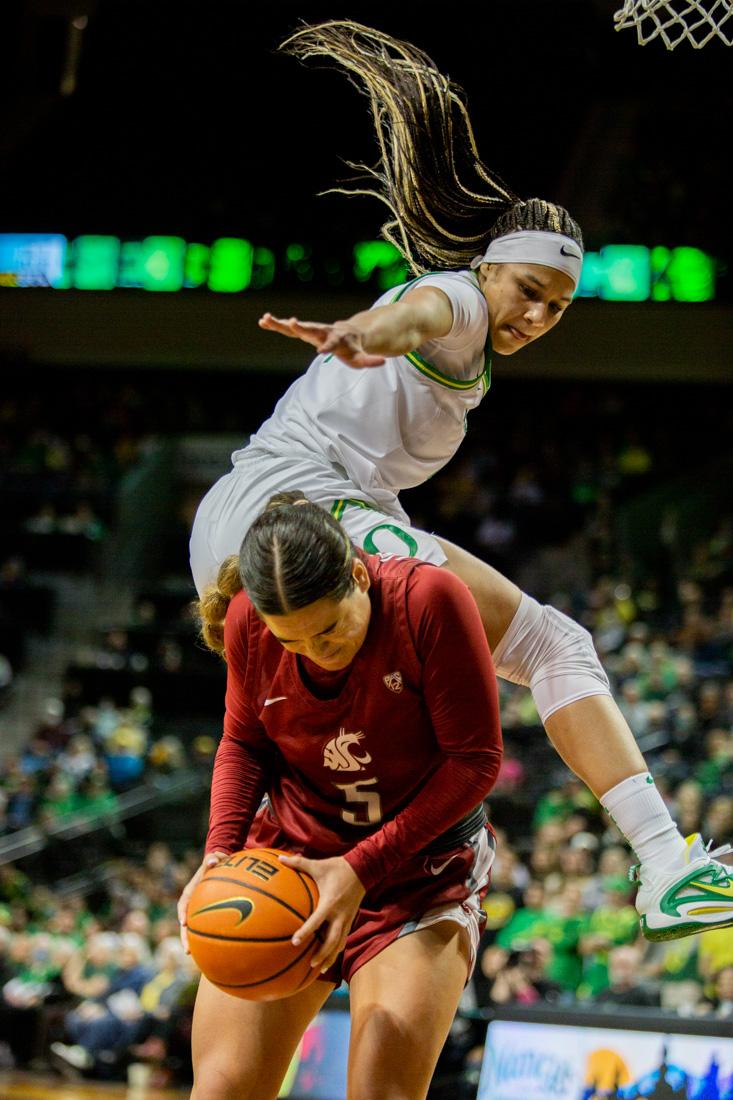 Ducks Endiya Rogers fouls Charlisse Leger-Walker. Oregon Ducks take on the Washington Cougars in Eugene, Ore. (Ali Watson/Emerald)