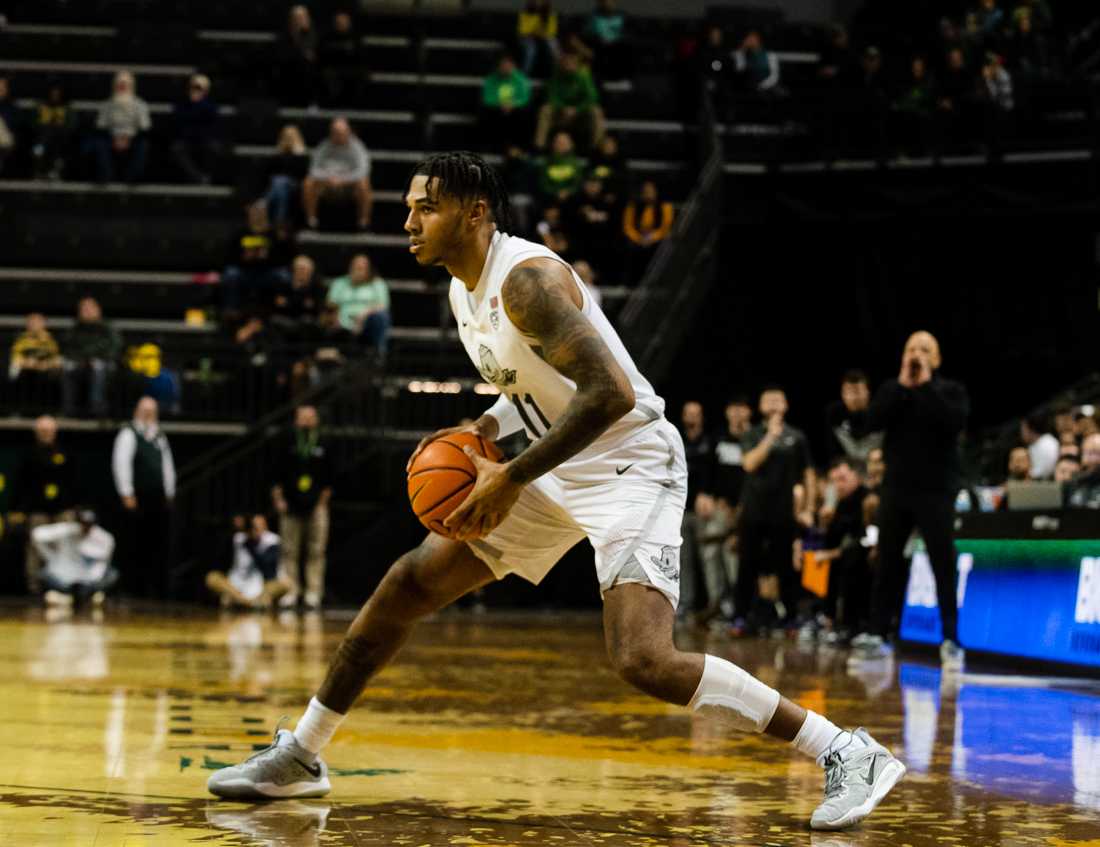 <p>Ducks guard Rivaldo Soares (11) looks for a direction to go while in possession of the ball. The University of Oregon Ducks defeat the University of Portland Pilots 78-56 at Matthew Knight Arena in Eugene, Ore., on December 17th, 2022. (Ian Enger/Emerald)</p>