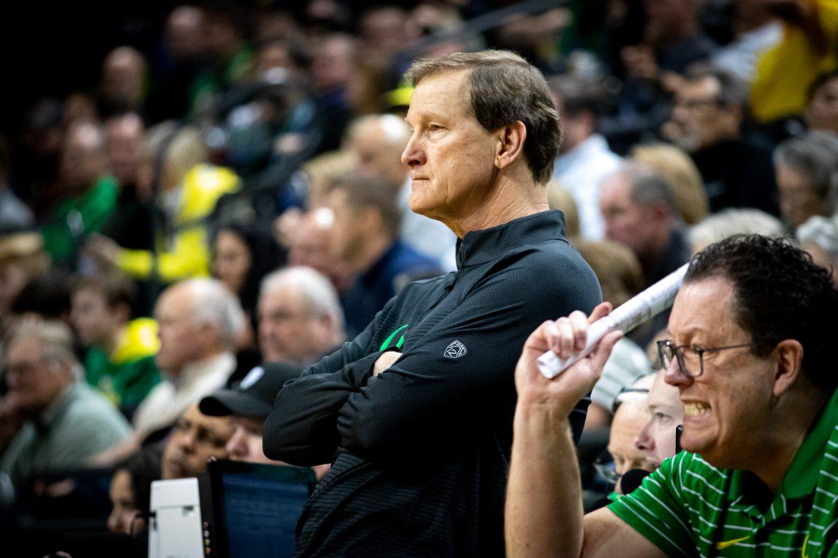 Coach Altman sits on the scorers table in frustration while executive director, Brian Fish, yells at his Ducks on the court.&#160;The University of Oregon Ducks host the Arizona State Sun Devils at Matthew Knight Arena in Eugene, Ore., on Jan. 12, 2023. (Jonathan Suni, Emerald)