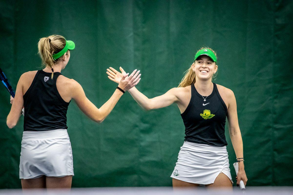 Myah Petchey smiles and high fives her teammate, Karin Young, after finishing off a great rally with a point.&#160;The Oregon Women's Tennis team hosts Portland State at the Student Tennis Center in Eugene, Ore., on January 20th. (Jonathan Suni, Emerald)