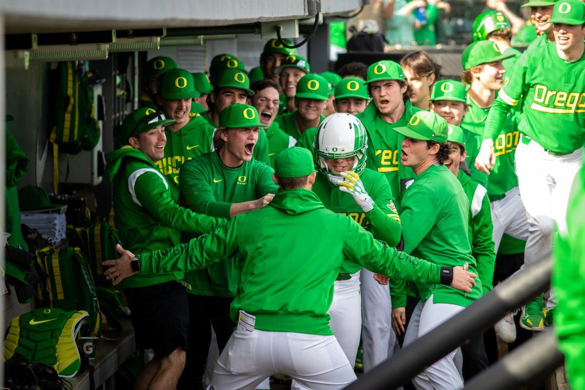 Gavin Grant receives a warm welcome to the dugout after hitting a pivotal home run. The Oregon Baseball team takes on Xavier for their season opening series on Feb. 19th, 2023, at PK Park. (Jonathan Suni, Emerald)