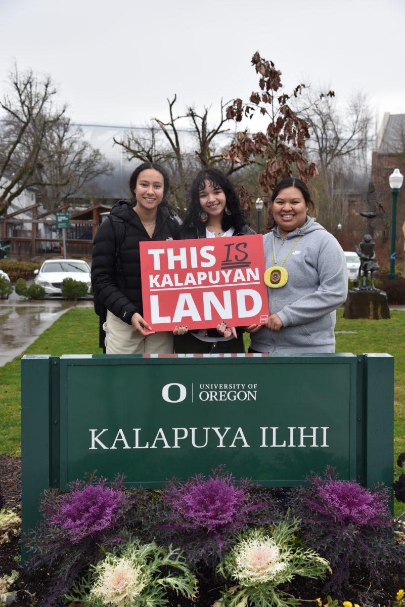 "From left to right: Daniele Sparks, Ray Arcoren and Jaycia Chickaway, attendees of the Taking Up Space event, stand in front of the Kalapuya Ilihi residence hall sign. The building is named after the traditional homelands of the Southern Kalapuya people on which the University of Oregon resides. Photo courtesy of Jonah Gomez."