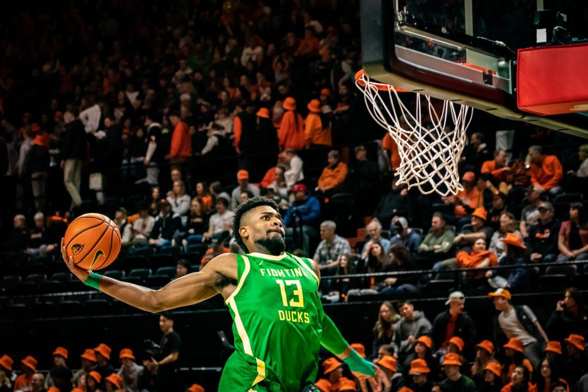 Quincy Guerrier shows off his dunking abilities to the opposing fans during warm-ups.&#160;The Oregon Ducks travel up to Corvallis to face their in-state rival the Oregon State Beavers on Feb. 25, 2023. (Jonathan Suni, Emerald)