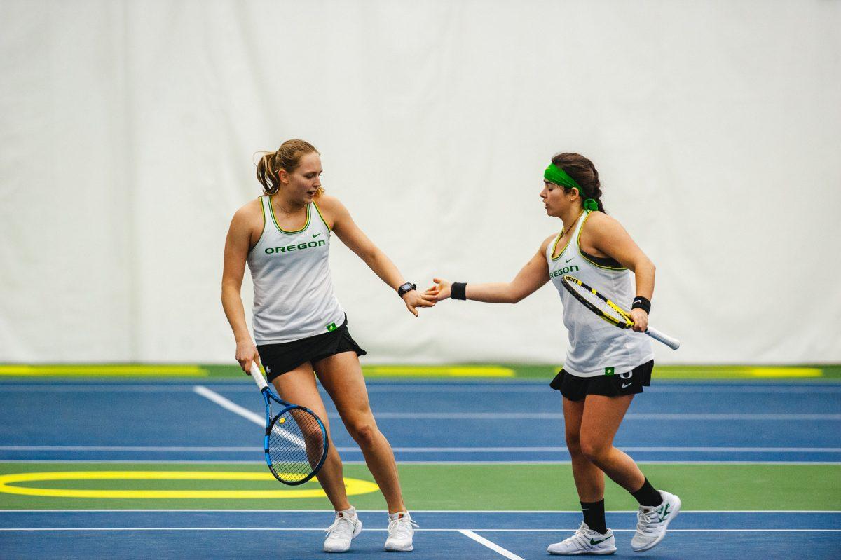 <p>Sophie Luescher (left) and Uxia Martinez Moral (right) celebrate after scoring a point. The University of Oregon Ducks faced off against the Eastern Washington University Eagles on Feburary 11, 2022. (Will Geschke/Emerald)</p>