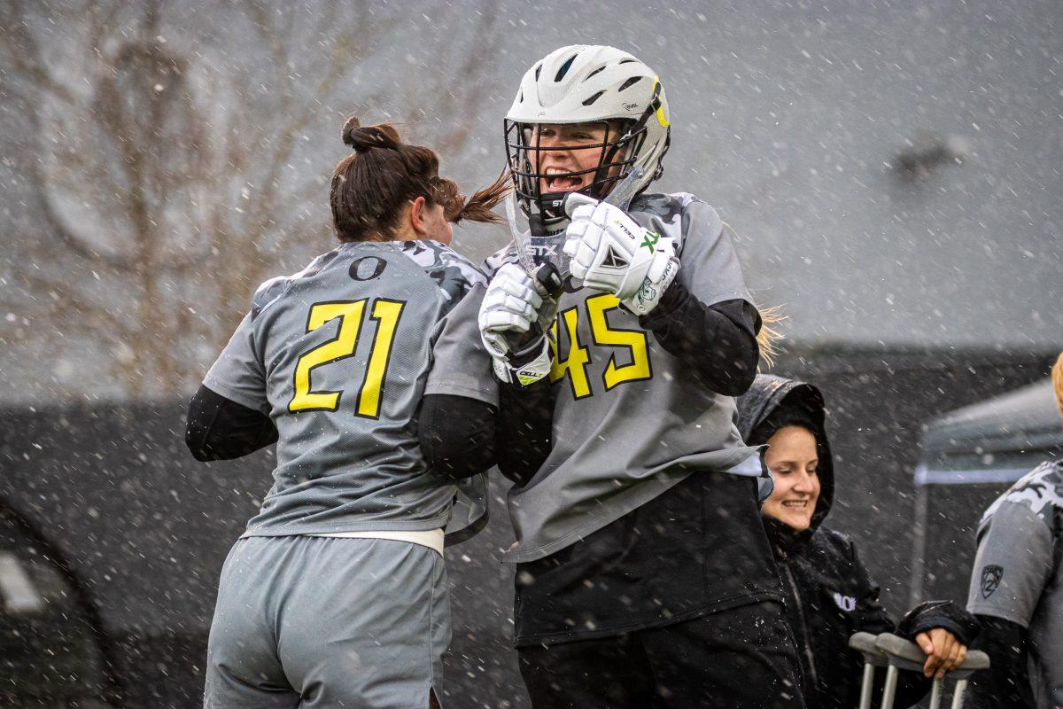 Oregon goalie, Cassidy Eckert (45), and Oregon defender, Sam Brescia (21), are introduced to the game.&#160;The Oregon Ducks Lacrosse team take on the Kennesaw State Owls at Pap&#233; Field in Eugene, Ore., on Feb. 26th, 2023. (Jonathan Suni, Emerald)