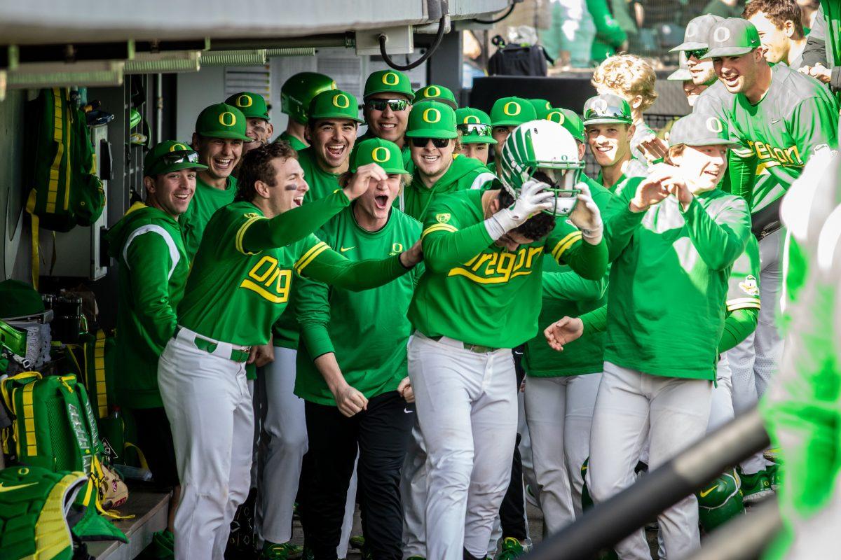 Josiah Cromwick takes off the home run helmet as the dugout cheers behind him.&#160;The Oregon Baseball team takes on Xavier for their season opening series on Feb. 19th, 2023, at PK Park. (Jonathan Suni, Emerald)