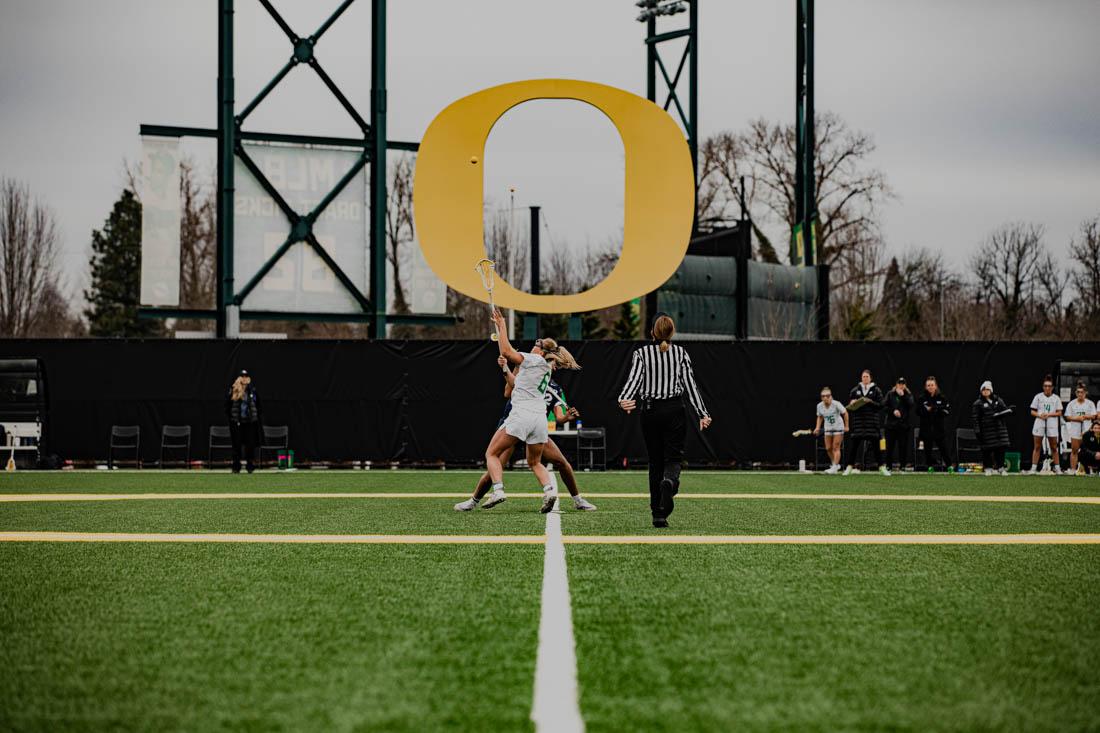 Ducks attacker Gabby Cleveland (6) tips off the game against Xavier University. The University of Oregon womens lacrosse team defeat the Xavier University Muskateers in their first home match at Pap&#233; Field in Eugene, Ore., on Feb. 12, 2023. (Maddie Stellingwerf/Emerald)