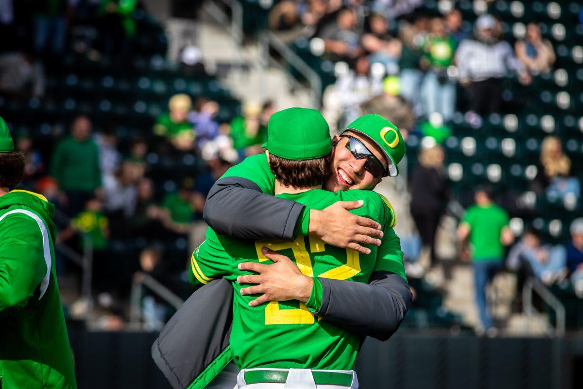 Turner Spoljaric and Dominic Hellman hug after a great inning for the Ducks.&#160;The Oregon Baseball team takes on Xavier for their season opening series on Feb. 19th, 2023, at PK Park. (Jonathan Suni, Emerald)