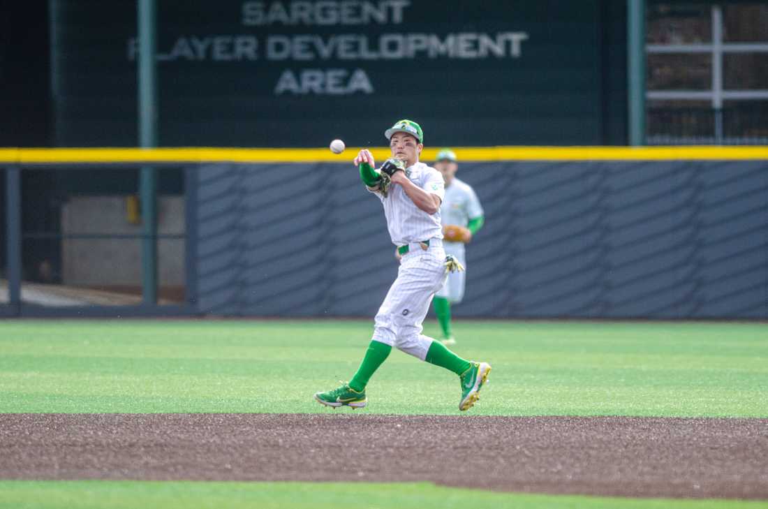 Oregon infielder Rikuu Nishida (56) makes a spinning throw to get the runner at first. The University of Oregon Ducks defeat Xavier University 9-2 at PK Park in Eugene, Ore., on February 18th, 2023. (Kai Kanzer/Emerald)