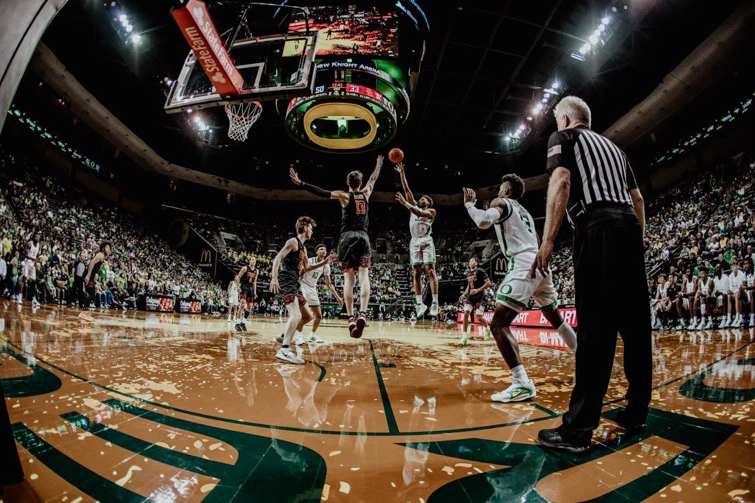 Ducks guard Keeshawn Barthelemy (3) makes a jumpshot against Trojans defense. University of Oregon Mens Basketball defeat the USC Trojans 78-60 at Matthew Knight Arena in Eugene, Ore., on Feb. 9, 2023. (Maddie Stellingwerf/Emerald)