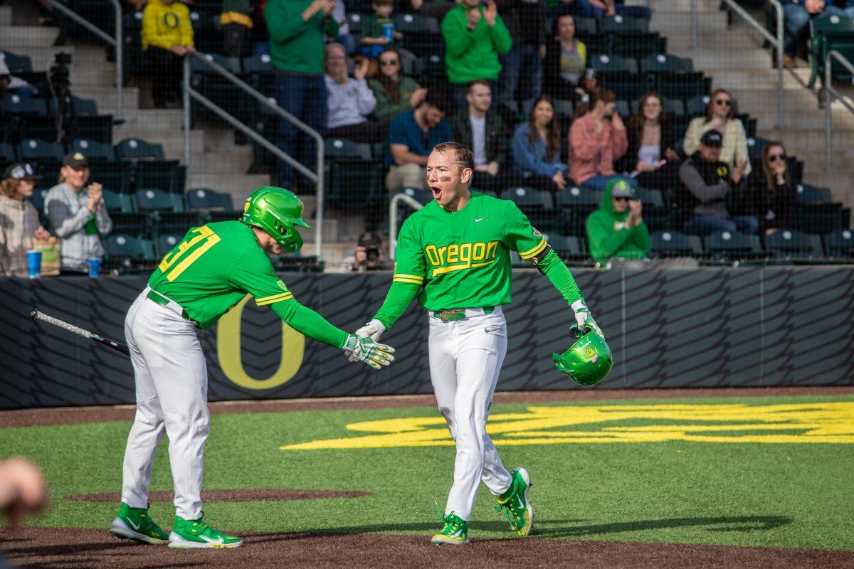 Gavin Grant yells as he high fives his teammate after running past home plate to complete his game winning home run.&#160;The Oregon Baseball team takes on Xavier for their season opening series on Feb. 19th, 2023, at PK Park. (Jonathan Suni, Emerald)