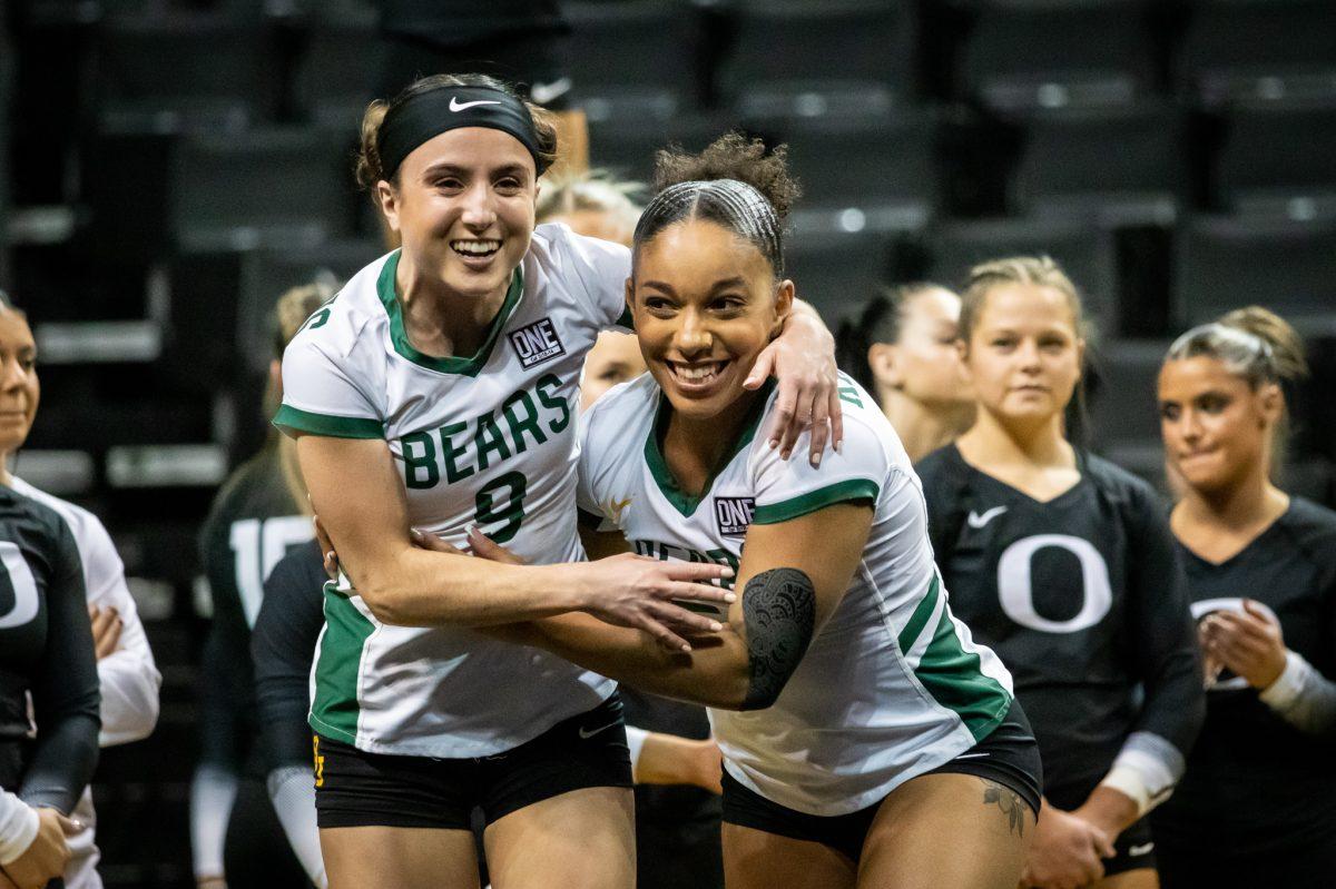 Two Baylor tumblers hug after finishing their performance.&#160;The Oregon Acrobatics and Tumbling team takes on Baylor on March 8th, 2023, at Matthew Knight Arena. (Jonathan Suni, Emerald)