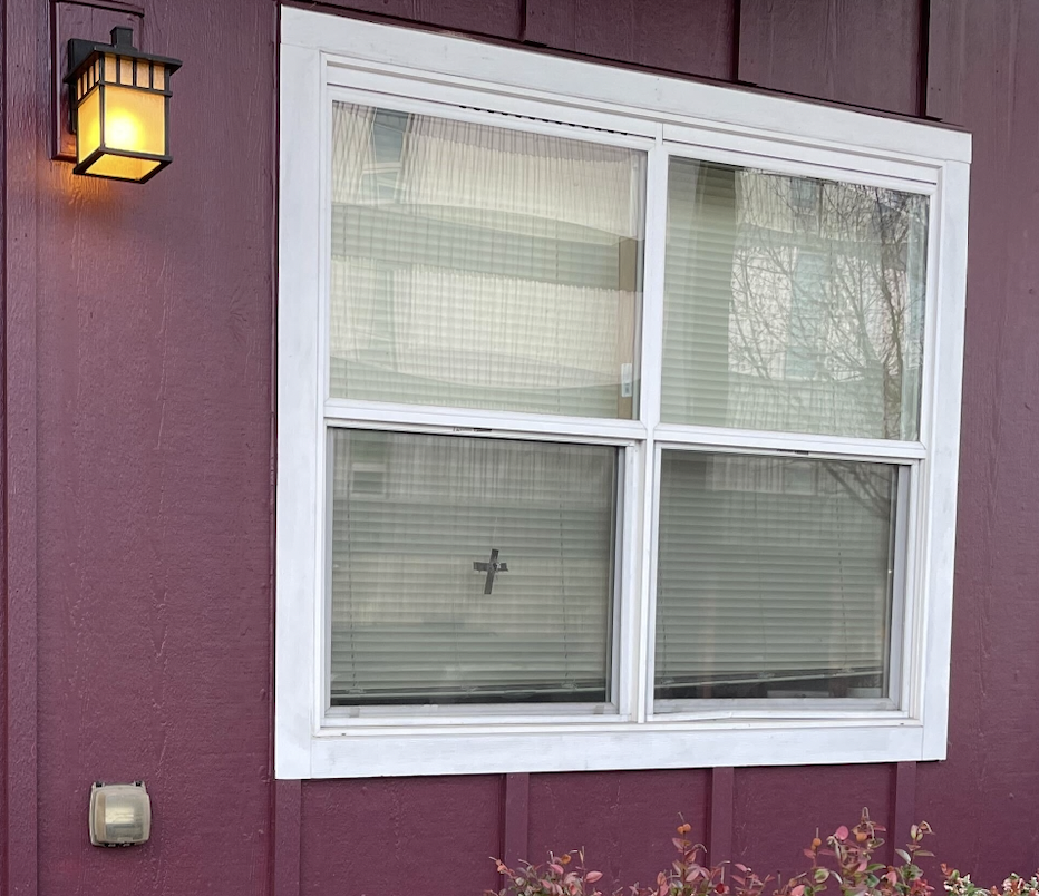 Black tape covers a gunshot in an apartment window on Hilyard Street (Gavin Gamez).