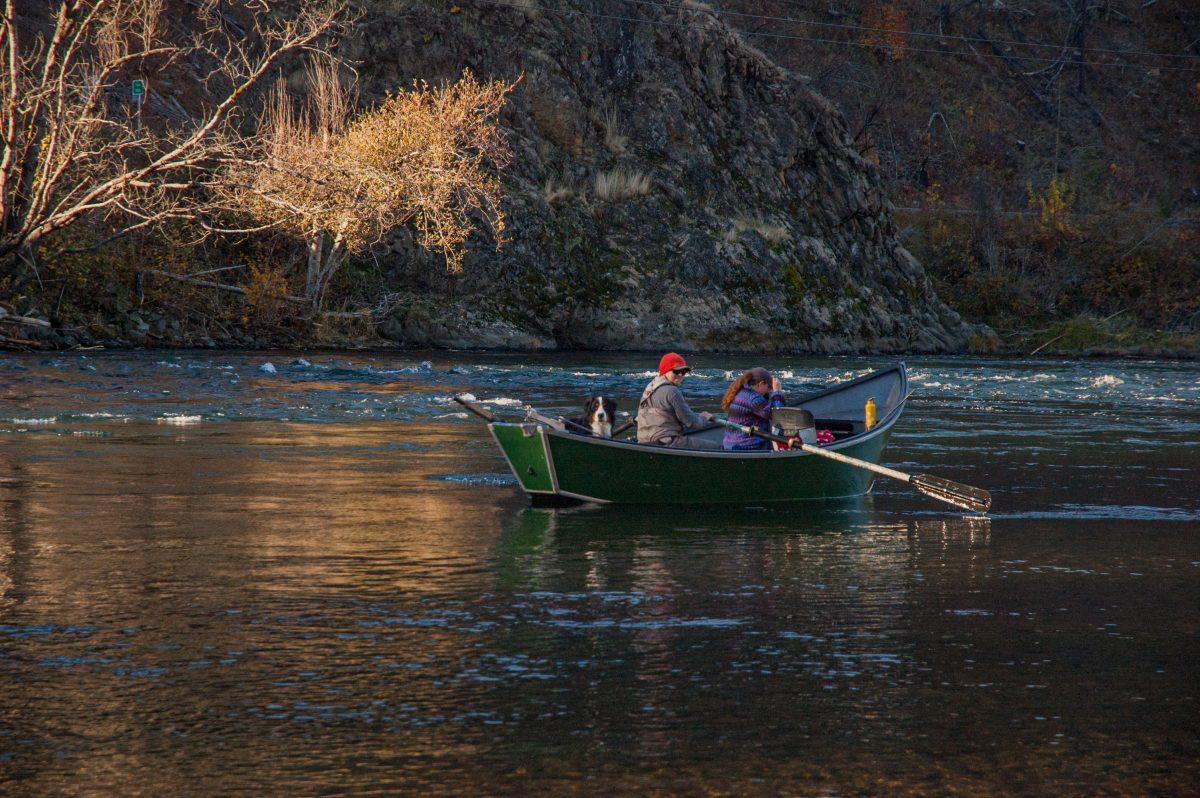 A fishing boat floats past Finn Rock Landing on the ice cold Mckenzie River which supports nurturing bull trout and Chinook salmon.