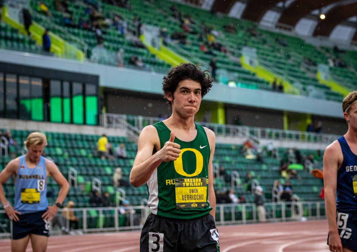 <p>Oregon running club representative, Owen Serriccho, gives a thumbs up after completing the 1500 meter run. (Jonathan Suni, Emerald)</p>