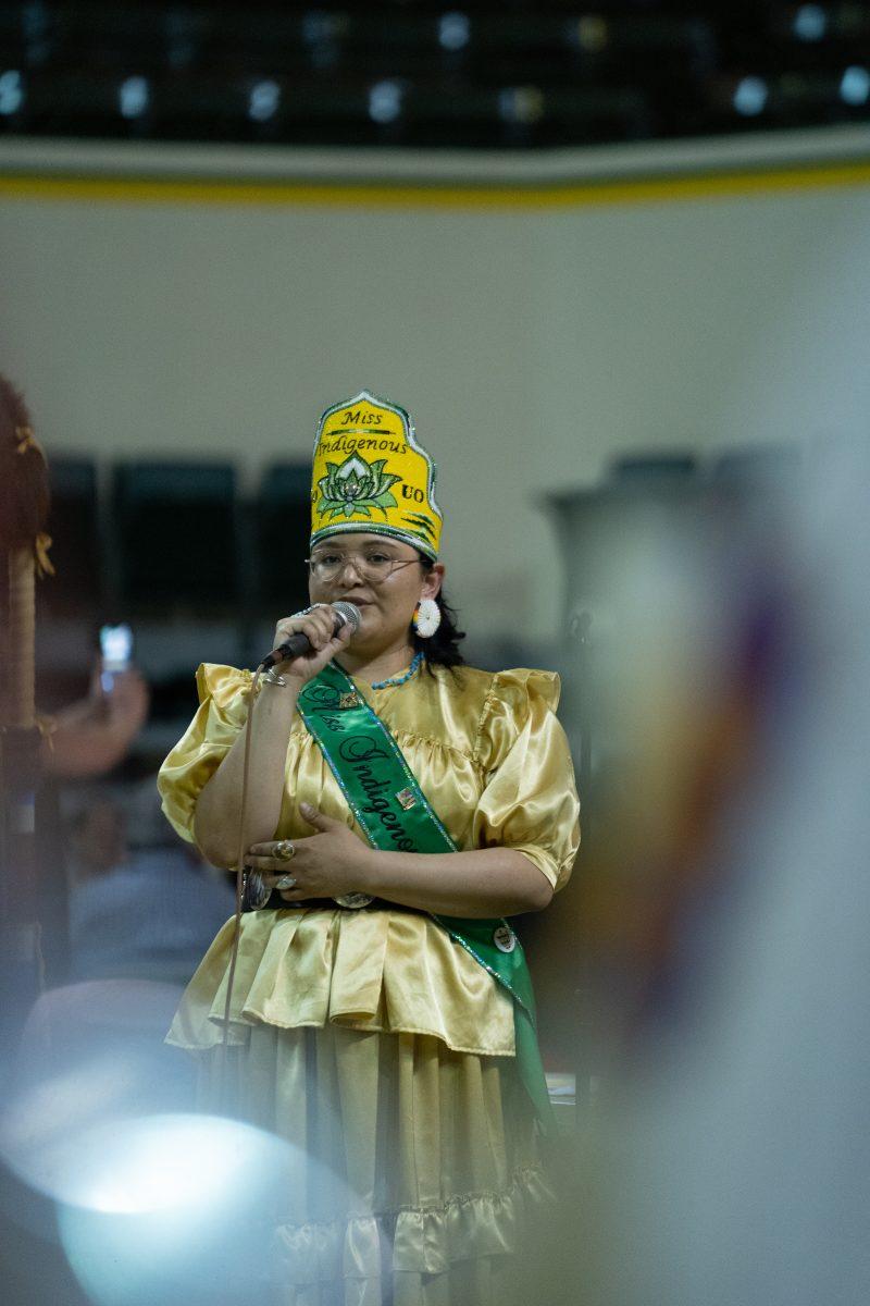 Miss Indigenous UO's Angela Noah leads attendees in opening prayer. The University of Oregons' Native American Student Union Hosts 55th Mother's Day Powwow. (Skyler Davis/Emerald)