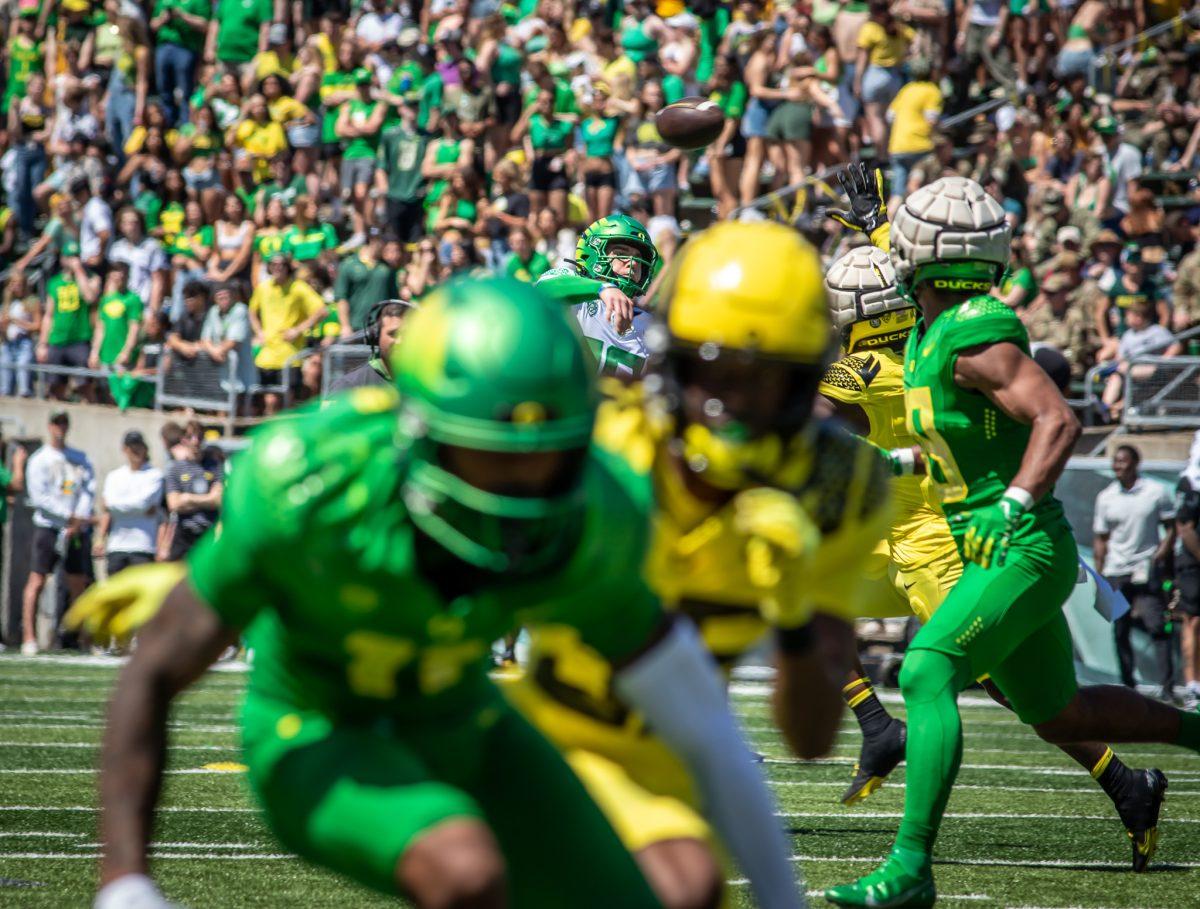 Bo Nix (10) throws out of the pocket while a green team receiver looks to break free from his yellow team defender.&#160;The University of Oregon holds their annual spring game&#160;at Autzen Stadium in Eugene, Ore., on April 29, 2023. (Jonathan Suni, Emerald)