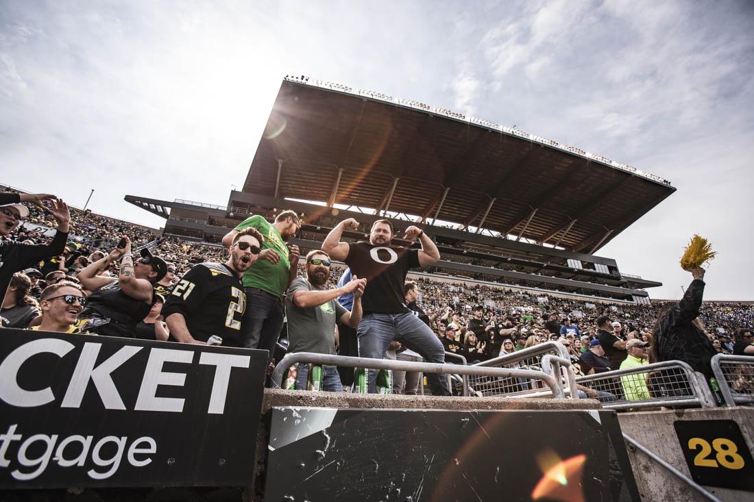 Duck fans enthusiastically show of their Oregon gear between huddles. University of Oregon Ducks Football defeat the BYU Cougars in a home match at Autzen Stadium in Eugene, Ore., on Sep. 17, 2022. (Maddie Stellingwerf/Emerald)