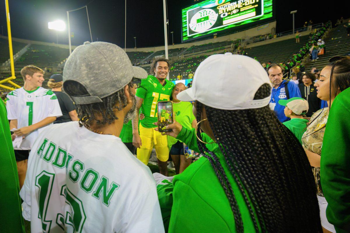 Bryan Addison (13) takes a photo after the game. The University of Oregon Ducks Football team defeated the University of Hawaii Rainbow Warriors in a home match at Autzen Stadium in Eugene, Oregon, on September 16, 2023. (Eric Becker/Emerald)