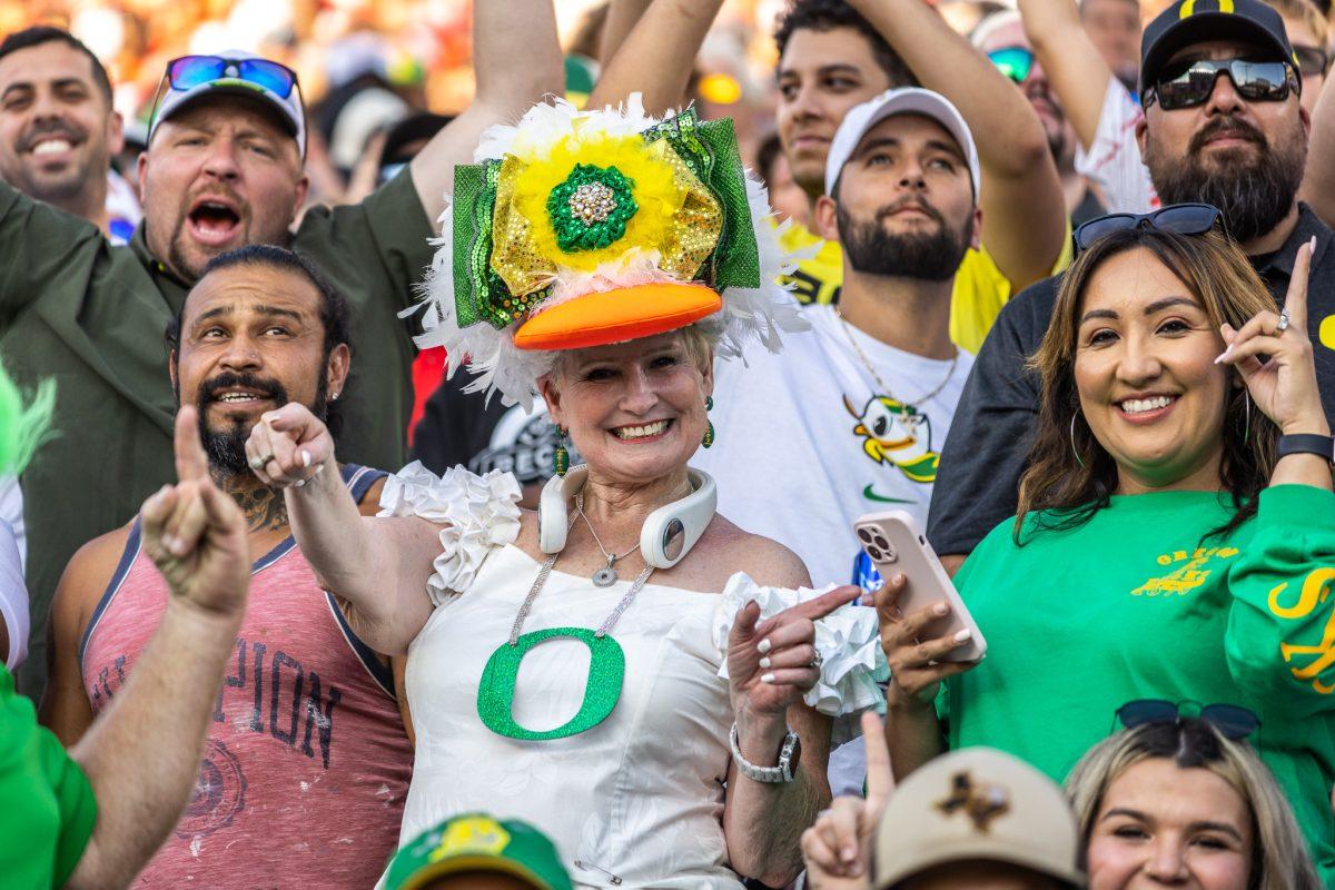 Well-known long-time Duck fan "Mimi" cheers on with fellow Oregon supporters after the Ducks gain a more comfortable lead.&#160;The Oregon Ducks battle in a close fight to ultimately beat the Texas Tech Red Raiders in their home opener at Jones AT&amp;T Stadium in Lubbock, Texas, on Sept. 9, 2023. (Jonathan Suni/Emerald)