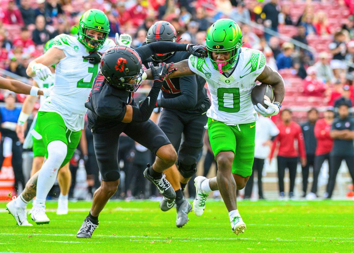 Bucky Irving stiff arms a defender during an Oregon touchdown run. The University of Oregon Ducks football team played the Stanford University Cardinals in an away match at Stanford Stadium in Stanford, Calif., on Sept. 30, 2023. (Eric Becker/Emerald)