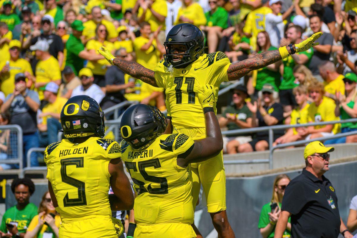 Troy Franklin is lifted up by Marcus Harper II after scoring. The University of Oregon Ducks Football team defeated the Portland State University Vikings in a home match at Autzen Stadium in Eugene, Oregon, on September 2, 2023. (Eric Becker/Emerald)