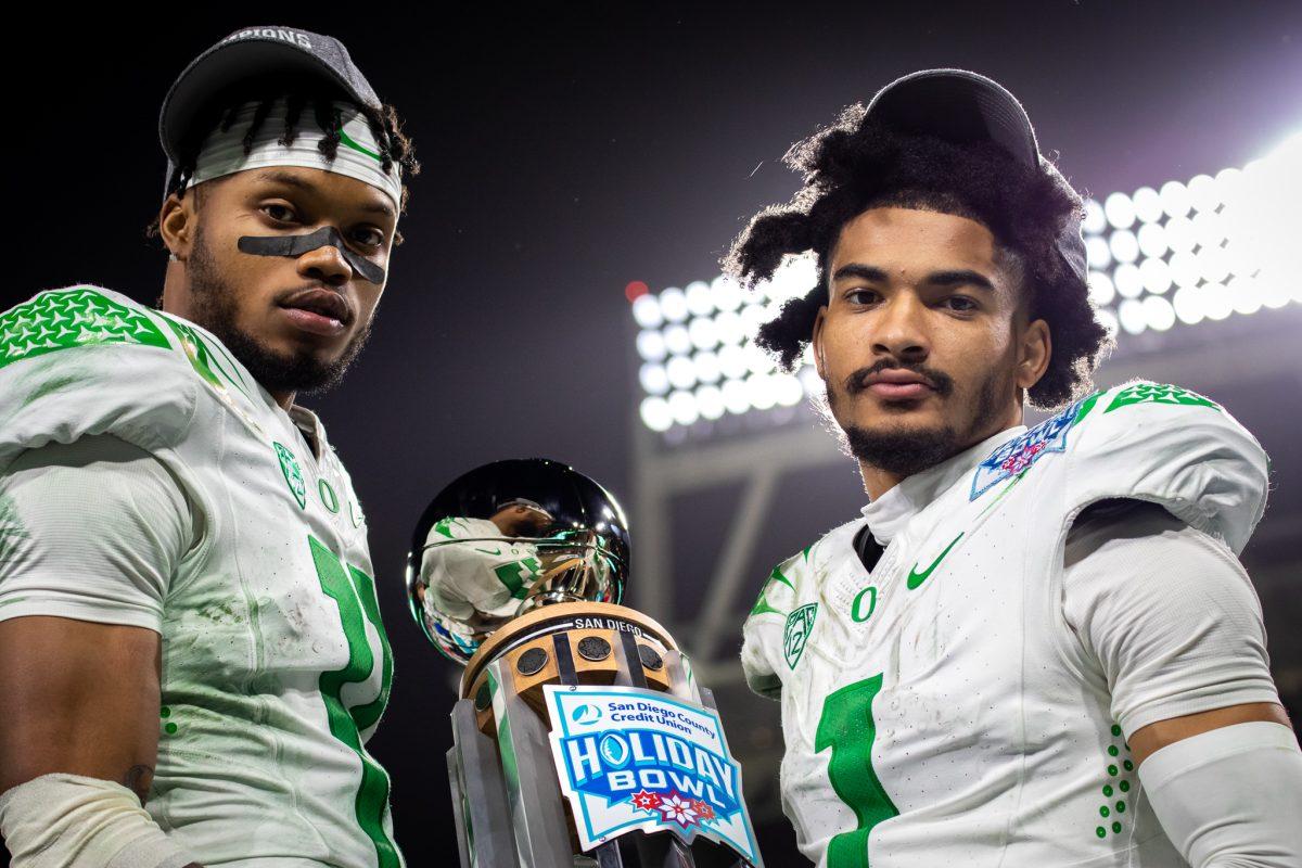 Oregon wide receivers, Troy Franklin (11) and Khris Hutson (1), pose with the Holiday Bowl trophy during the postgame celebration.&#160;The Oregon Ducks face the North Carolina Tar Heels in the annual Holiday Bowl at Petco Park in San Diego, CA, on December 28th, 2022. (Jonathan Suni, Emerald)