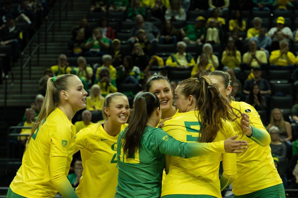 The Oregon Ducks celebrate in unison with beaming smiles after scoring against the Wildcats. The University of Oregon Ducks volleyball team secured a 3-0 victory against the University of Arizona at the Matthew Knight Arena in Eugene, Oregon, on October 13, 2023. (Photo by Sebastian Flores/Emerald)