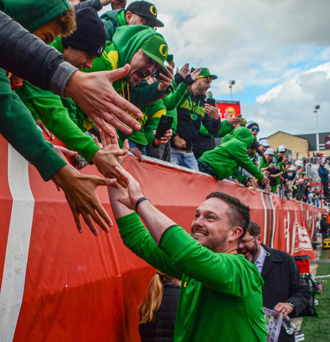 Oregon Head Coach, Dan Lanning celebrates with Duck fans after beating the University of Utah 35-6 at Rice-Eccles Stadium in Salt Lake City, Utah. (Kai Kanzer/Emerald)