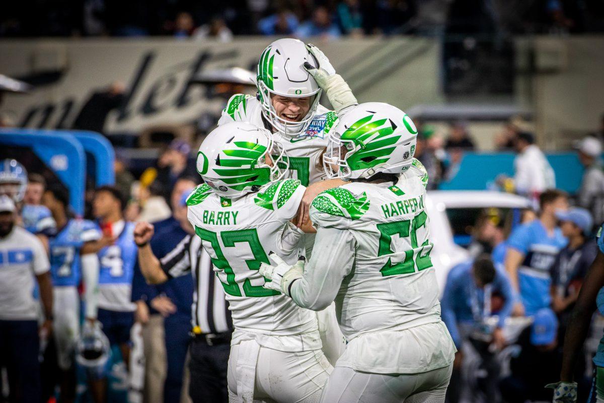 Adam Barry (93) and Marcus Harper (55) pick Oregon kicker, Camden Lewis (49), up and celebrate with him after making the game winning extra point.&#160;The Oregon Ducks face the North Carolina Tar Heels in the annual Holiday Bowl at Petco Park in San Diego, CA, on December 28th, 2022. (Jonathan Suni, Emerald)