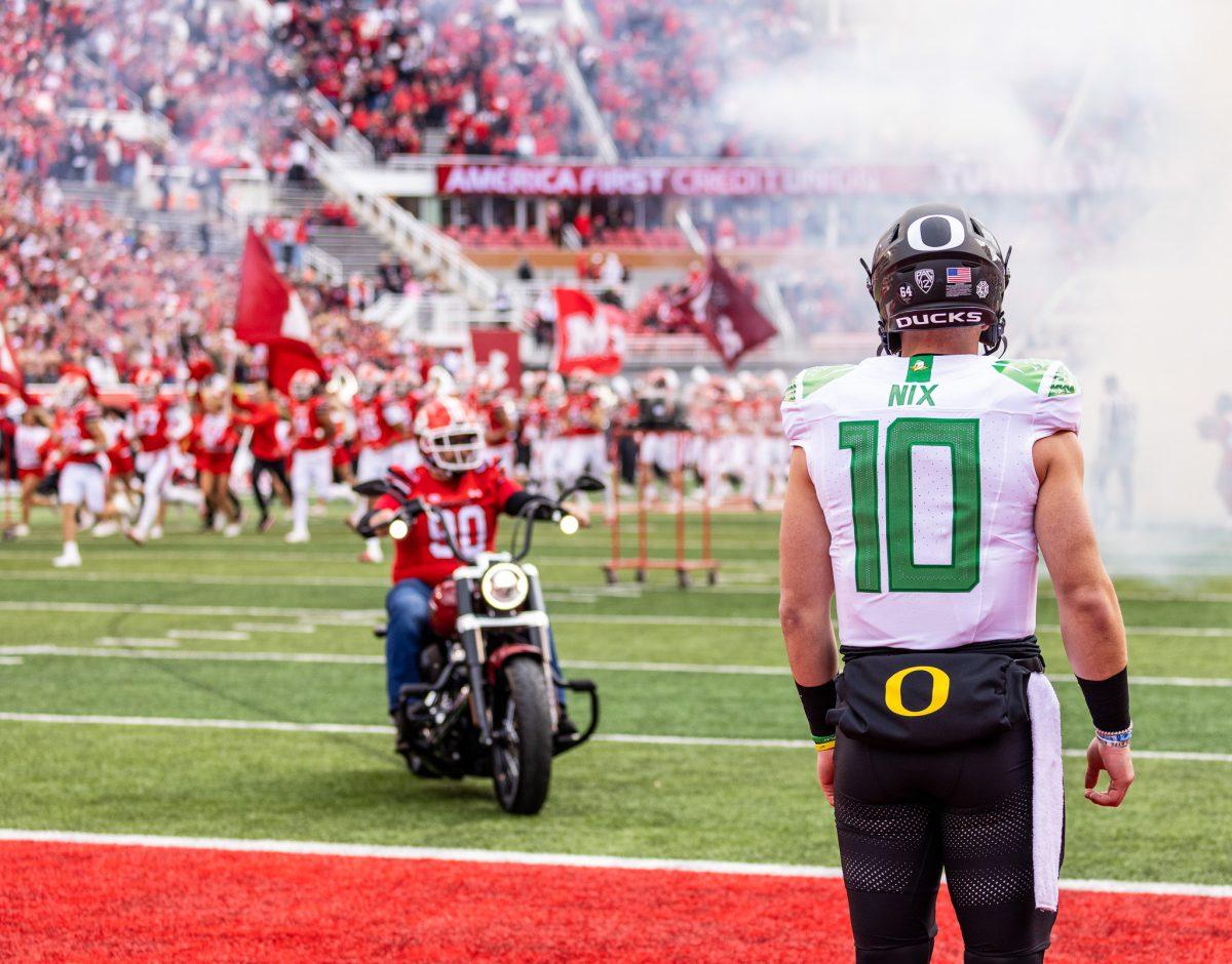 Bo Nix watches the Utah Utes run onto the field as he prepares to get on the field for the opening drive.&#160;The No. 8 Oregon Ducks defeat the No. 12 Utah Utes 35-6 at Rice-Eccles Stadium in Salt Lake City, Utah, on Oct. 28, 2023. (Jonathan Suni/Emerald)