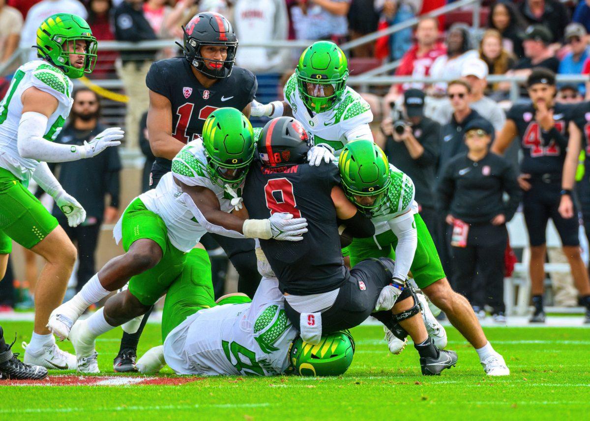 Oregon Defenders swarm Stanford quarterback Justin Lamson (8).&#160;The University of Oregon Ducks football team defeated the Stanford University Cardinals in an away match at Stanford Stadium in Stanford, Calif., on Sept. 30, 2023. (Eric Becker/Emerald)