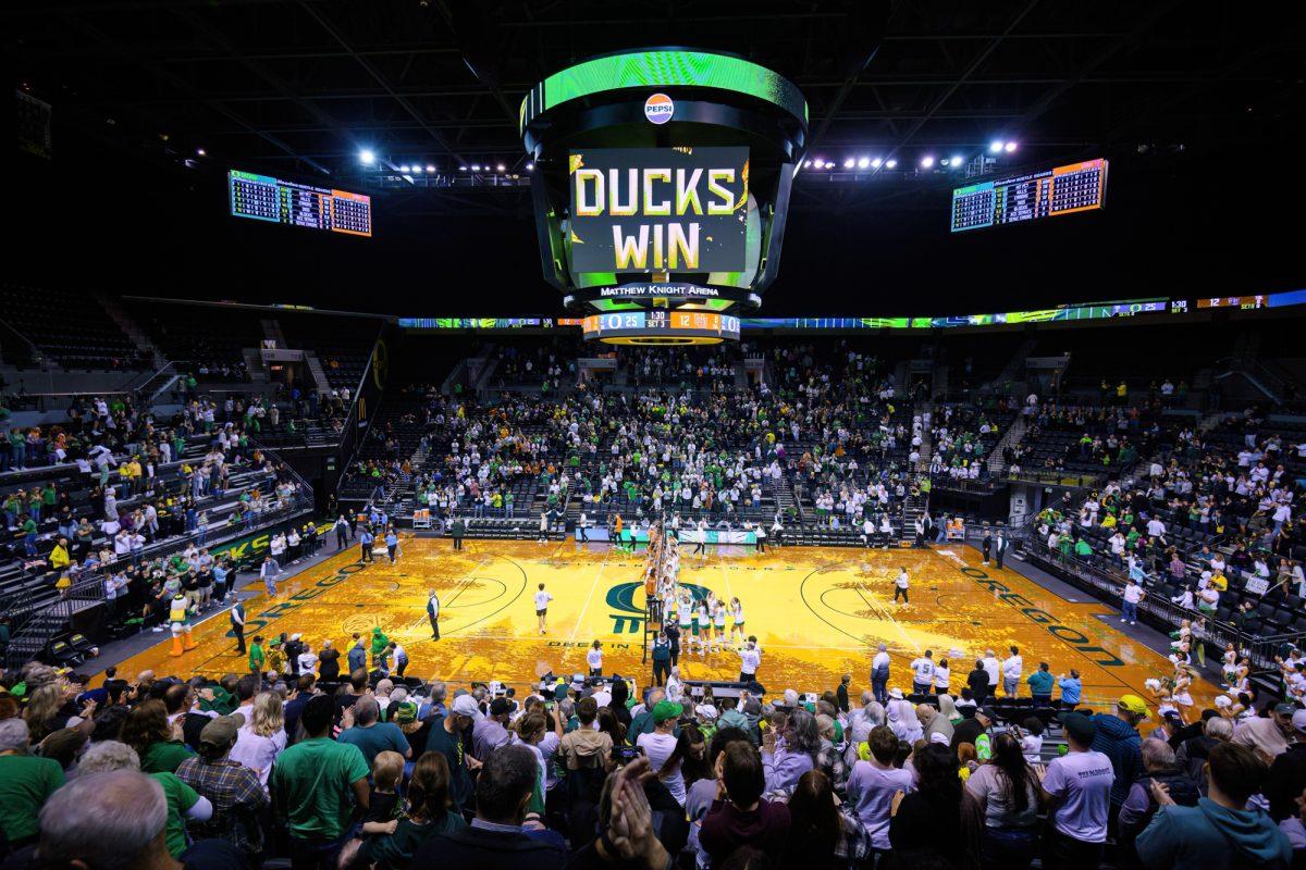 Both teams meet at the net after the match to greet one another. The University of Oregon Ducks Volleyball team defeated the University of Utah Utes in a home match at Matthew Knight Arena in Eugene, Ore., on Nov. 3, 2023. (Eric Becker/Emerald)