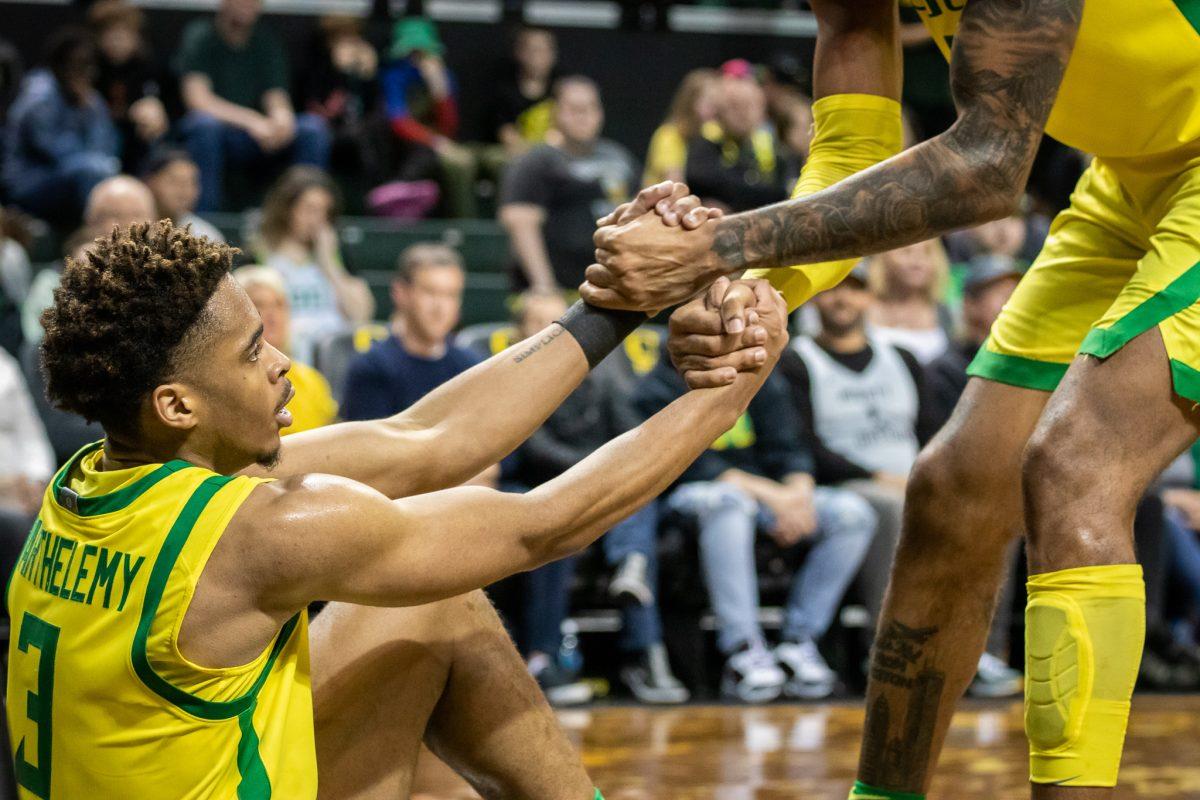 Keeshawn Barthelemy receives help getting up after getting knocked down by a UCF player.&#160;The Oregon Mens Basketball team host the University of Central Florida at Matthew Knight Arena for the second round of the NIT in Eugene, Ore., on March 19th, 2023. (Jonathan Suni, Emerald)