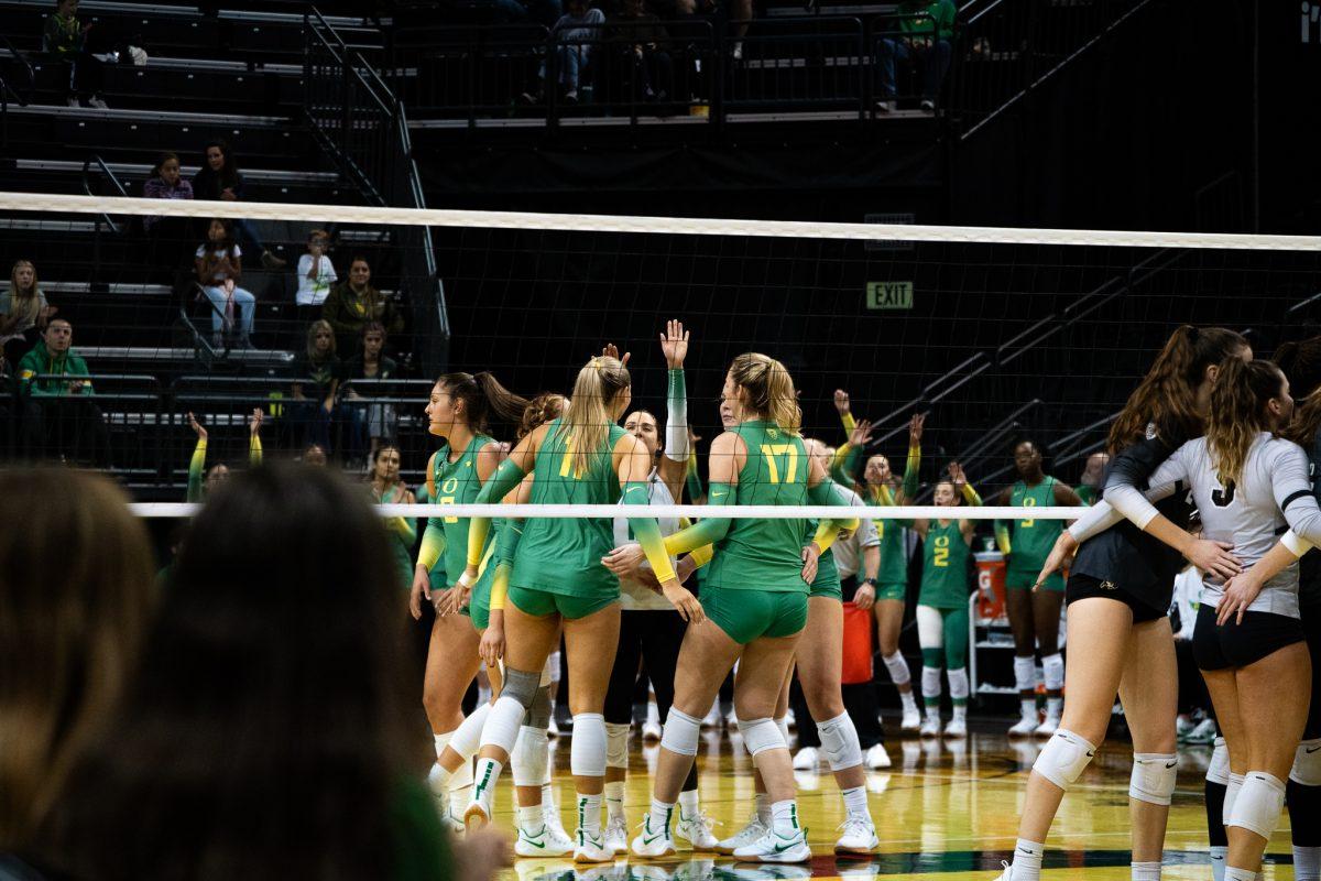 Colorado's middle blocker, Skyy Howard (7), launches a powerful attack while facing pressure from Ducks' opposite, Morgan Lewis (11), and middle blocker, Kara McGhee (17). The Oregon Ducks Volleyball team defeated the Colorado Buffaloes 3-1 in a home match at Matthew Knight Arena in Eugene, Ore., on Nov. 5, 2023. (Sebastian Flores/Emerald)