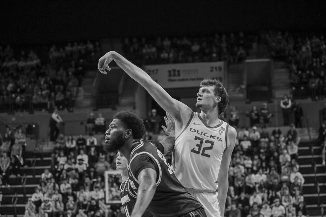 Nate Bittle (32) watches his shot land in the hoop while being defended. The Oregon Ducks beat the Montana Grizzlies 75-61 on Friday November 10, 2023 at Matthew Knight Arena in Eugene, Ore. (Lulu Devoulin/ Emerald)