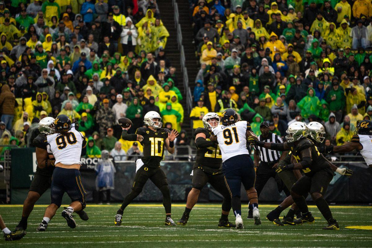 Ducks quarterback Bo Nix (10) attempts a far throw to his fellow teammates while under pressure by the Golden Bears defense. The Oregon Ducks defeat the California Golden Bears 63-19 at Autzen Stadium in Eugene Ore., on Nov. 4, 2023. (Sebastian Flores/Emerald)