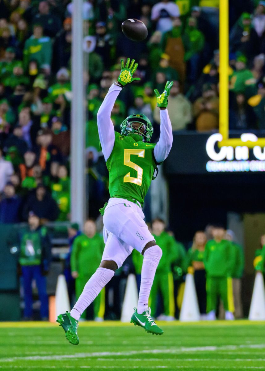 Oregon DB Khyree Jackson (5) attempts to intercept the ball. The University of Oregon Ducks Football team defeated Oregon State University 31-7 in a home match at Autzen Stadium in Eugene, Ore., on Nov. 24, 2023. (Eric Becker/Emerald)