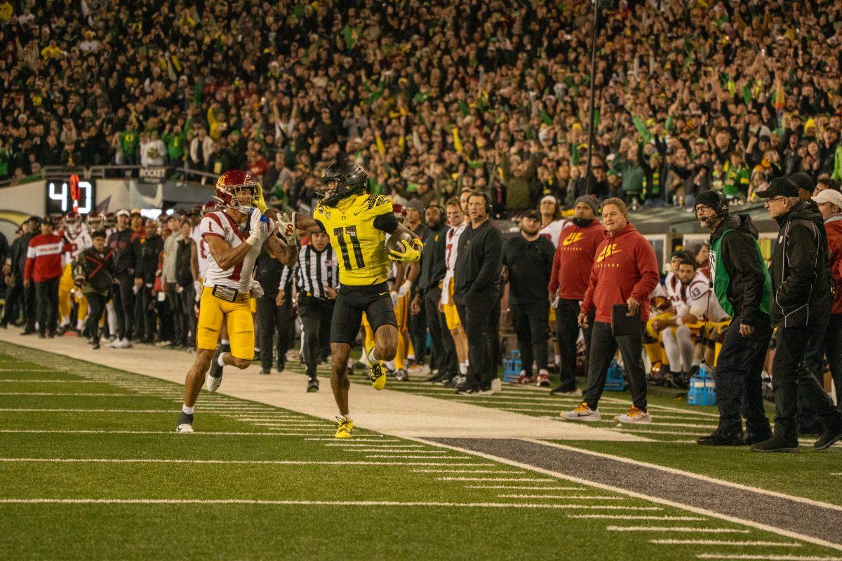 Troy Franklin(11) stiff arming the defense. The University of Oregon Ducks Football team played the University of Southern California in a home match at Autzen Stadium in Eugene, Ore., on Nov. 11, 2023. (Spencer So/Emerald)