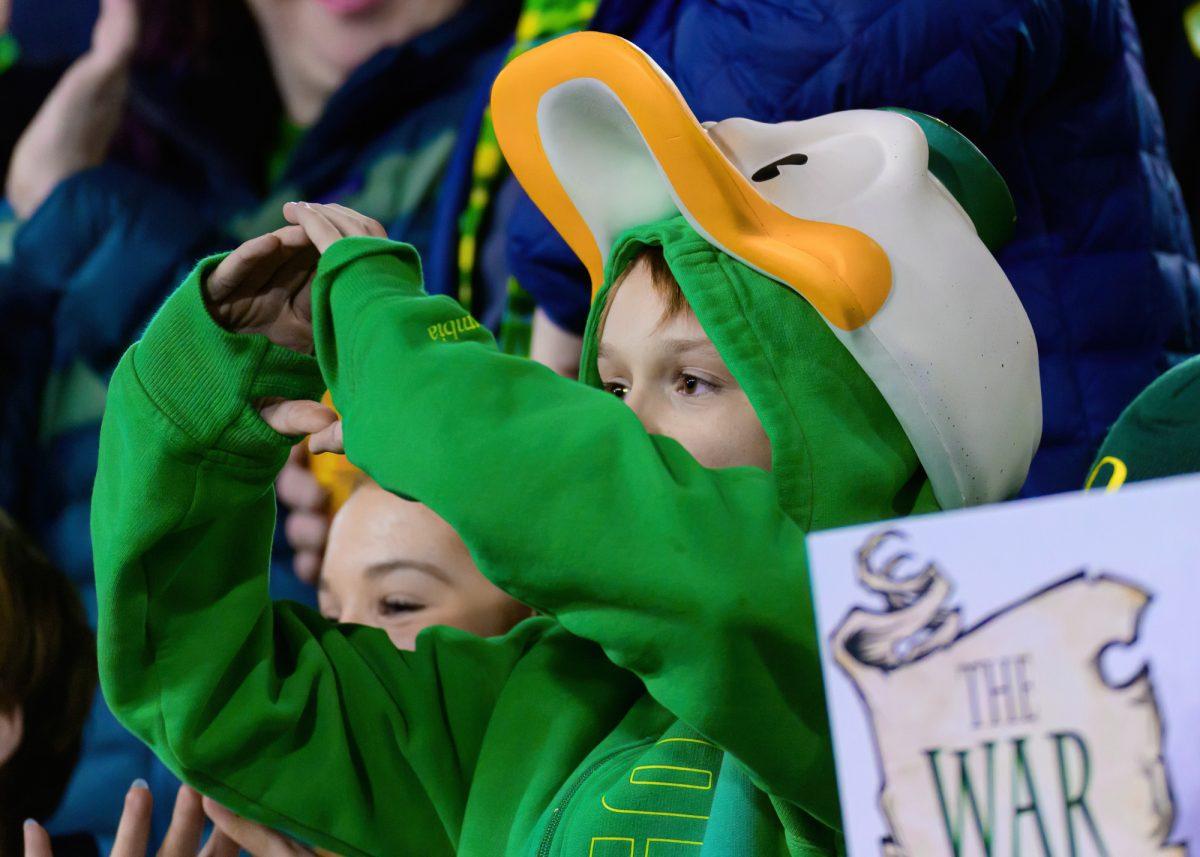 A young Ducks fan throws the "O" from the stands. The University of Oregon Ducks Football team defeated Oregon State University 31-7 in a home match at Autzen Stadium in Eugene, Ore., on Nov. 24, 2023. (Eric Becker/Emerald)