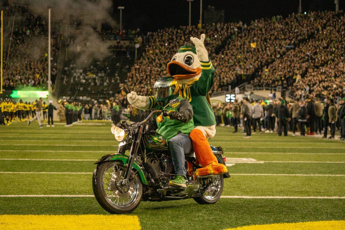 The Oregon Duck riding a motorcycle pre-game. The University of Oregon Ducks Football team played the University of Southern California in a home match at Autzen Stadium in Eugene, Ore., on Nov. 11, 2023. (Spencer So/Emerald)