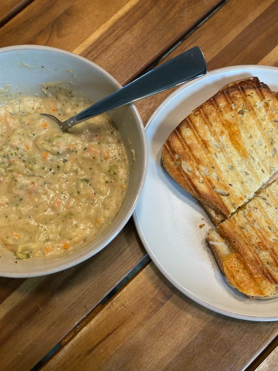 A hearty bowl of roasted cauliflower broccoli cheddar soup with a grilled cheese on the side. (Jess McComb/Emerald)