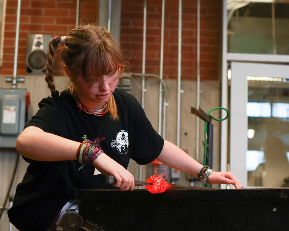 Stella Vissers turns the metal rod that holds her glass to ensure it stays centered. &#8220;Even though my study is science based, I&#8217;m a creative person. This is how I keep myself happy,&#8221; Vissers said. The Craft Center&#8217;s glass blowing studio reopened this term after it was closed for the last three years. (Romie Avivi Stuhl/Emerald)