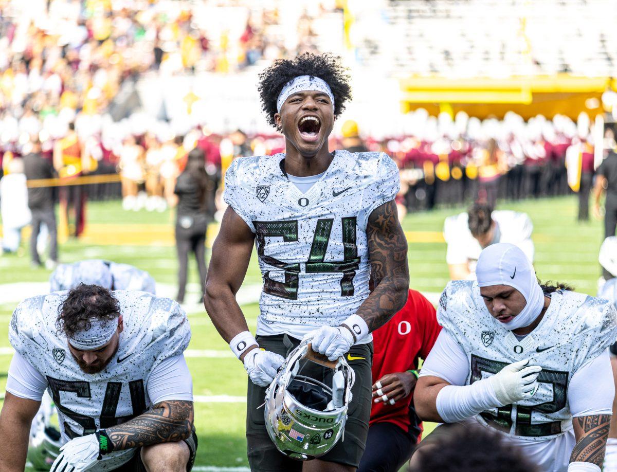 <p>Freshman linebacker, Jerry Mixon (54), yells pregame to get himself in the right mentality. The Ducks look to regain glory in Tempe as they left with their season dreams crushed in their last go around in 2019. The Oregon Ducks crush the Arizona State Sun Devils at Mountain America Stadium in Tempe, Ariz., on Nov. 18, 2023. (Jonathan Suni/Emerald)</p>